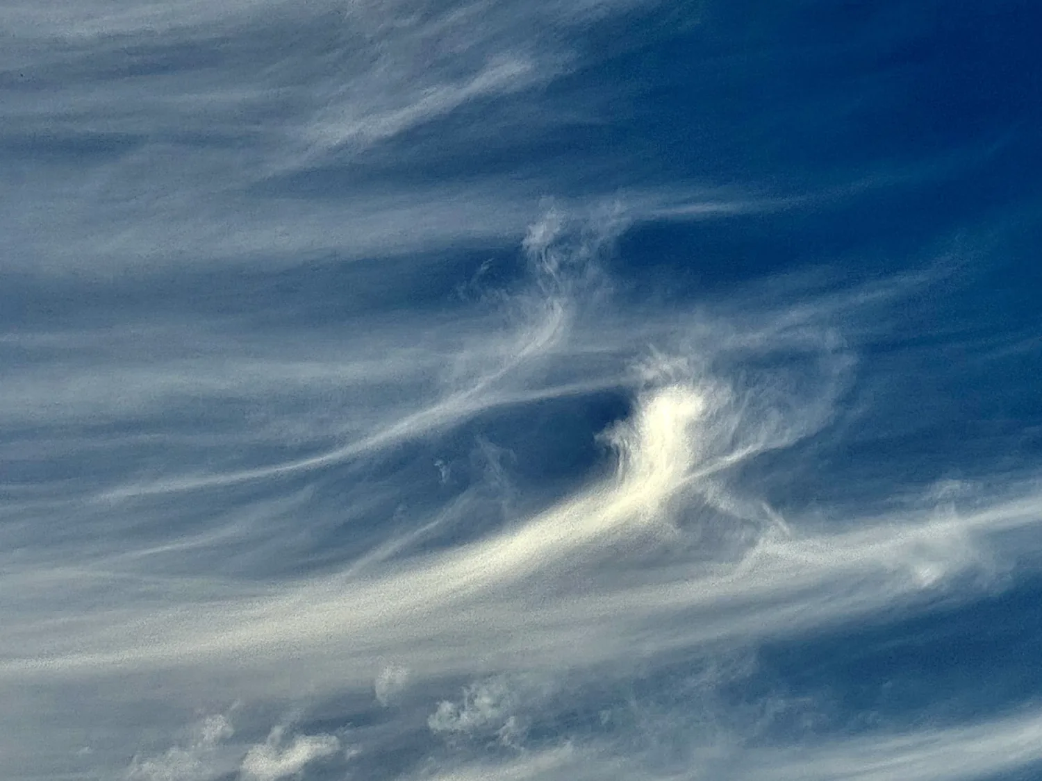 Wisps of cloud in a clear sky